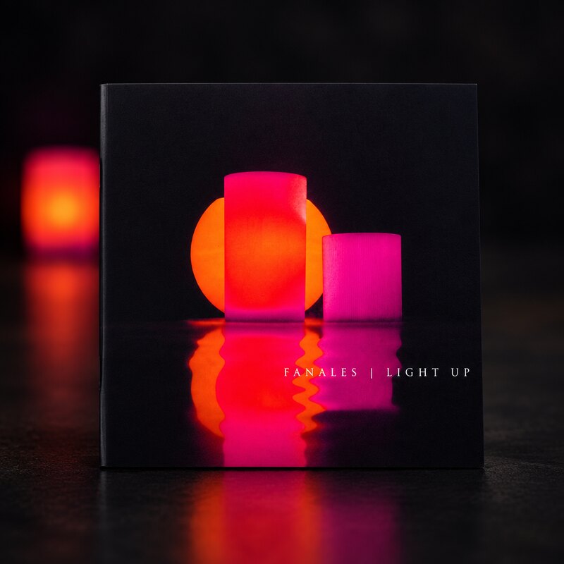 The cover, with the wax forms lit.